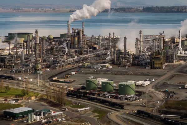 Aerial view of petroleum refinery with storage tanks and processing towers