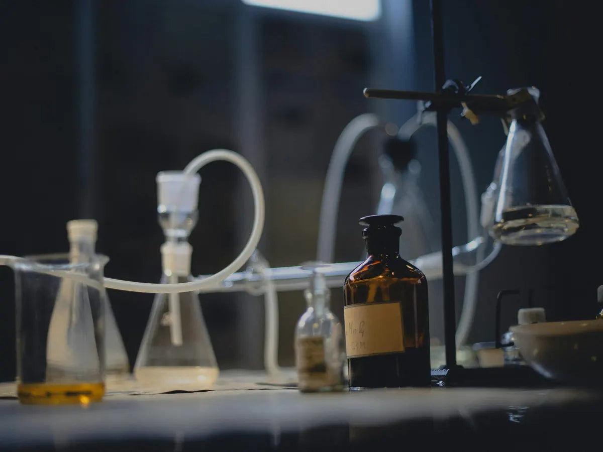 Laboratory glassware and reagent bottles on a bench