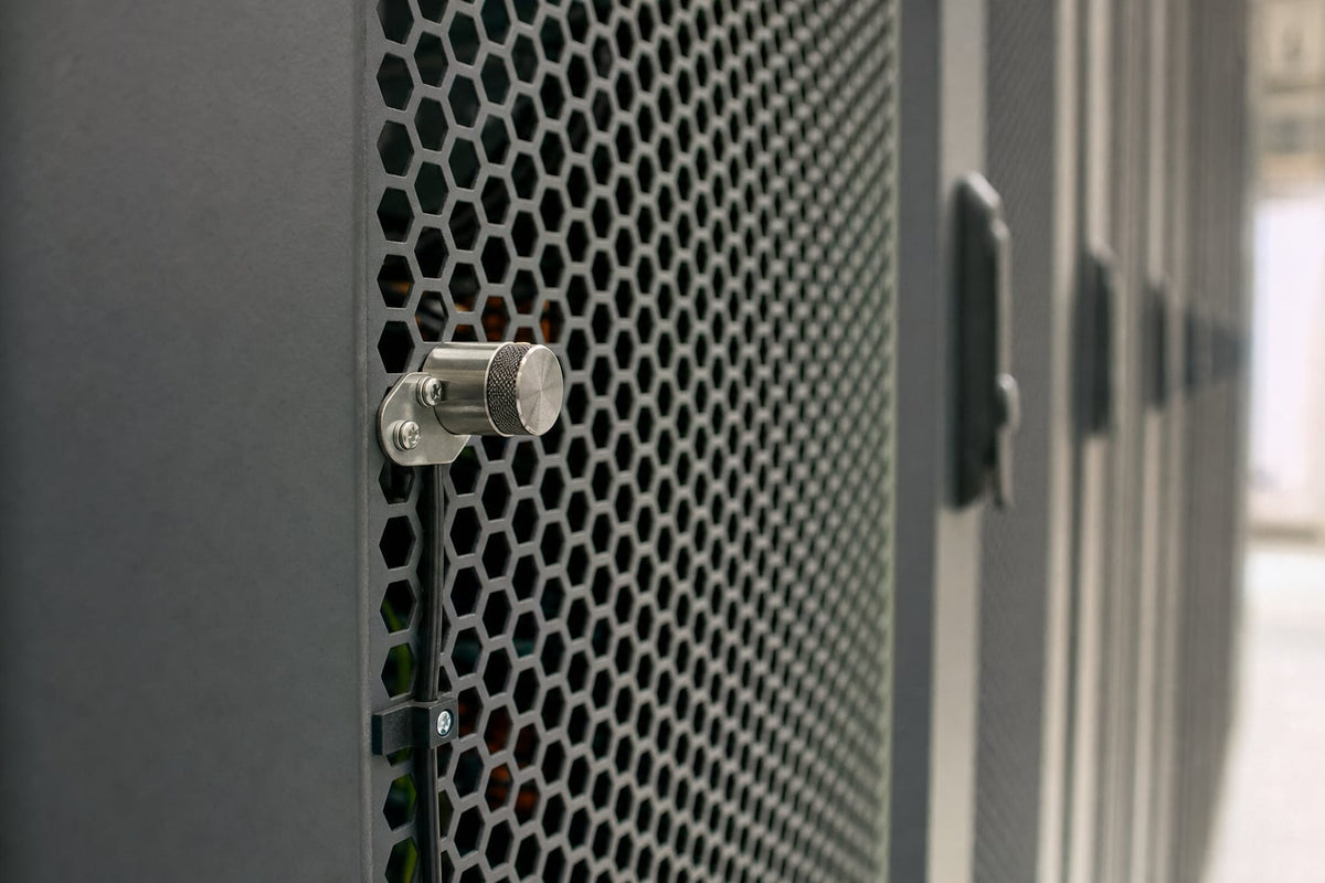 A temperature probe mounted on a perforated metal cabinet door