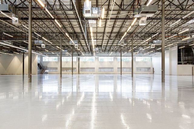 Empty industrial warehouse interior with polished concrete floor in Houston, Texas.