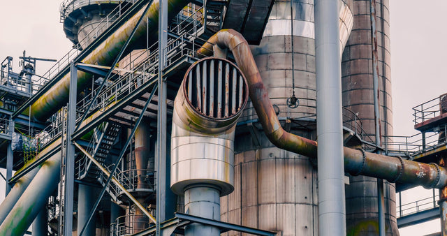 Close-up view of rusted industrial plant pipes and structures showcasing engineering marvels.