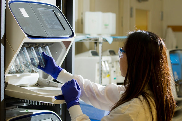 Researcher holding test tubes in a laboratory setting