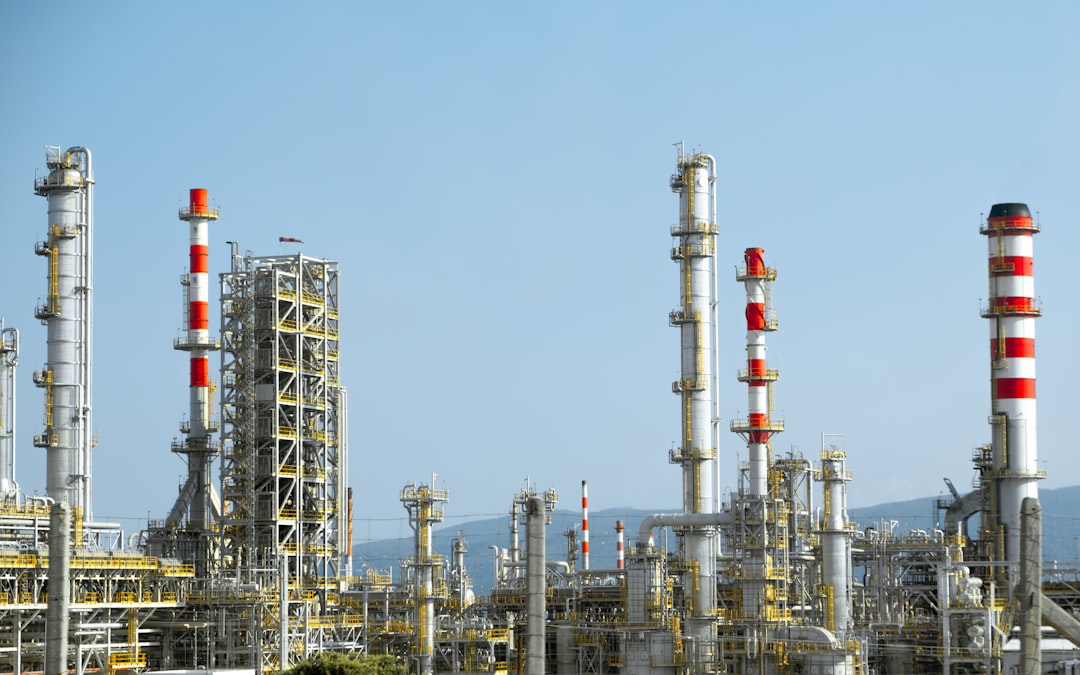 Industrial chemical facility with red and white pipes