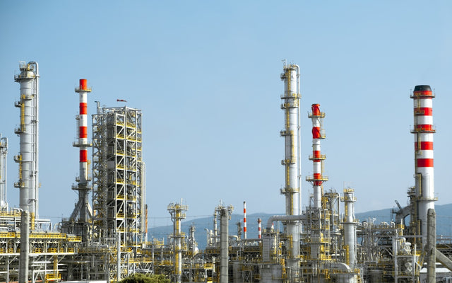 Industrial chemical facility with red and white pipes