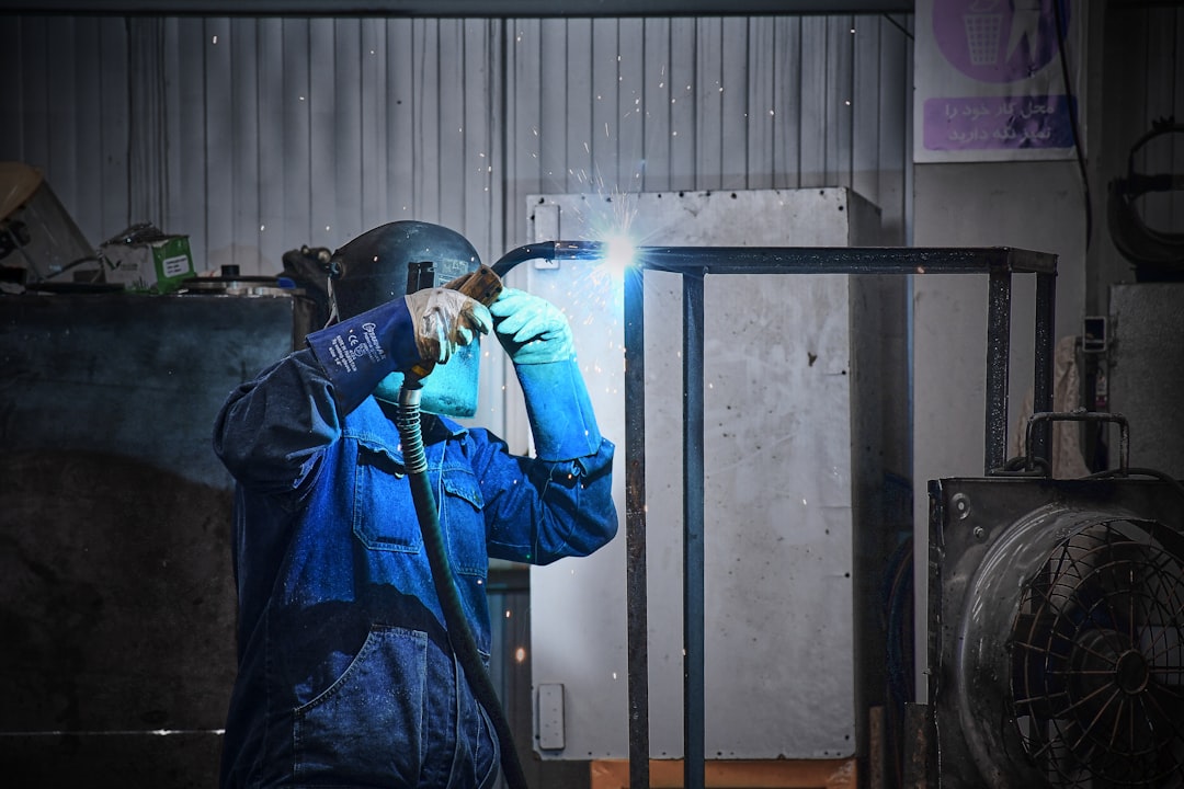 A man in a blue jacket holding a flashlight
