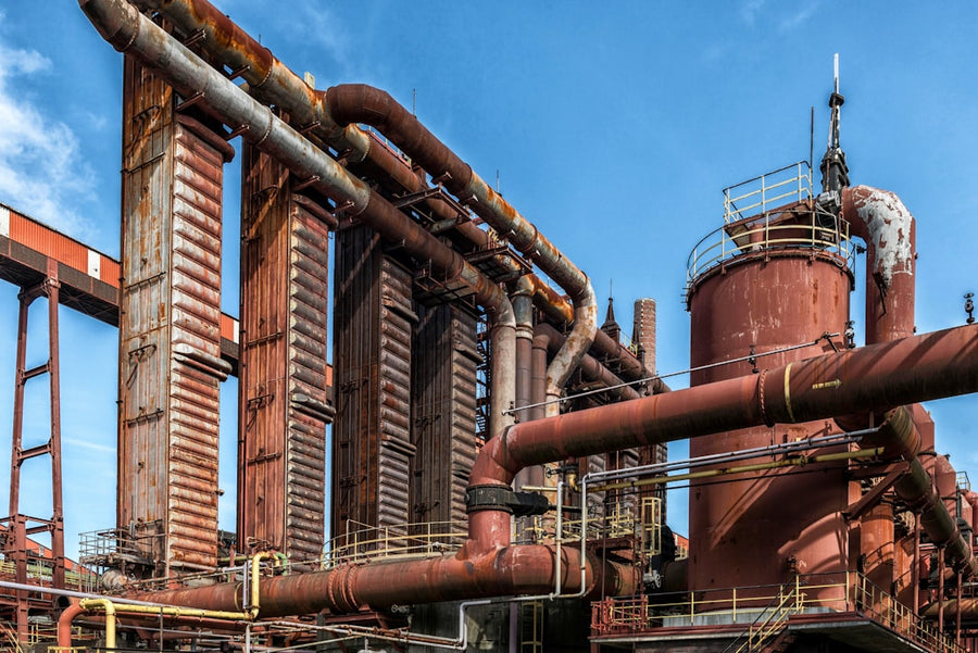 Rusty metal industrial plant against a blue sky.