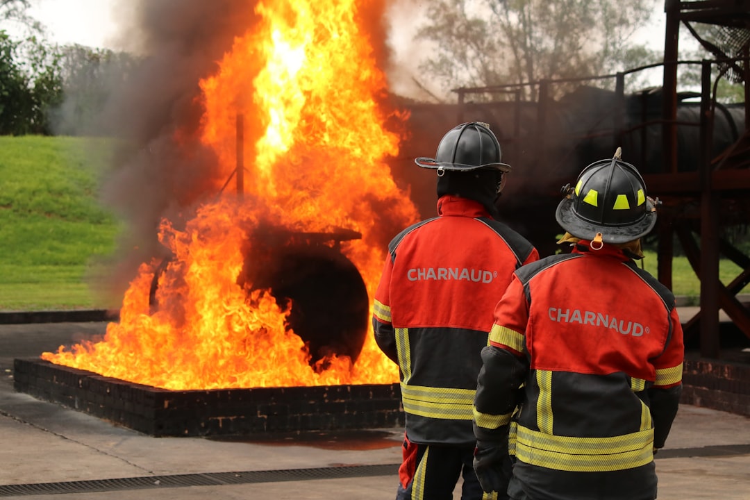 Firefighters observe a burning fire during a training exercise.