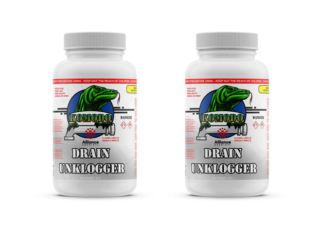 Two 2-lb plastic bottles of Alliance Chemical Komodo Drain Unklogger with white ribbed caps and labeled containers.