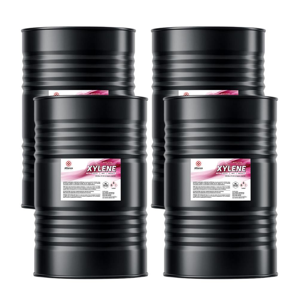 4x55 gallon black steel drums of industrial xylene solvent with hazmat warning labels, ribbed sidewalls, and tamper-evident seals.