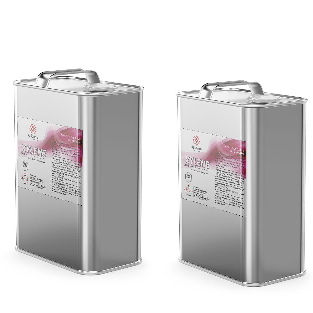 1-quart metal canisters of industrial xylene solvent in silver-finish containers with pink-labeled hazard warnings and secure handles.